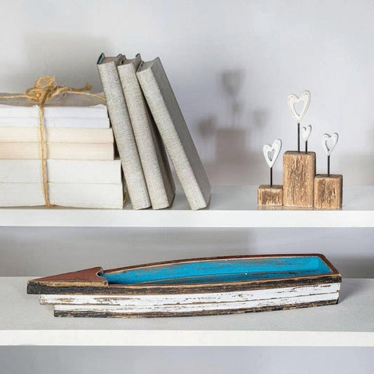 Mellow Monkey rustic wooden boat with distressed blue interior and white exterior, red accent. Coastal decor.