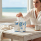 Mellow Monkey papier mache tissue box cover featuring a sailboat decoupage design on a white wooden table.