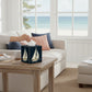 Mellow Monkey papier mache tissue box cover featuring a sailboat and anchor design on a coastal living room table.