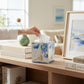 Mellow Monkey sailboat decoupage paper mache tissue box cover with hand-painted edges on a wooden shelf.