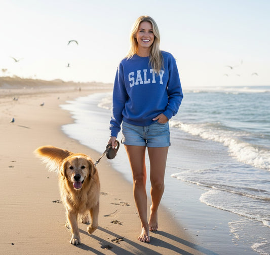 Mellow Monkey Salty Graphic Sweatshirt in heather royal blue with white distressed lettering. Cozy crewneck for casual wear.