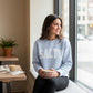 Mellow Monkey light blue crewneck sweatshirt with white "SALTY" graphic. Model is holding a coffee cup.