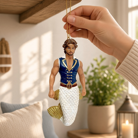 Mellow Monkey December Diamonds Salty Seamen merman ornament with a blue vest and white glittery tail held by hand