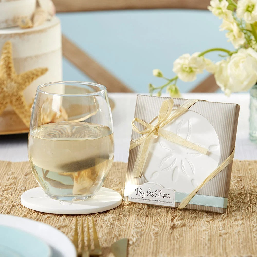 Mellow Monkey sand dollar stone coaster with a white embossed design, displayed in a gift box with a raffia ribbon.