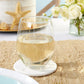 Mellow Monkey sand dollar stone coaster under a stemless wine glass on a textured table setting