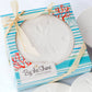 Mellow Monkey By the Shore sand dollar stone coaster set in decorative beach-themed gift box with raffia ribbon
