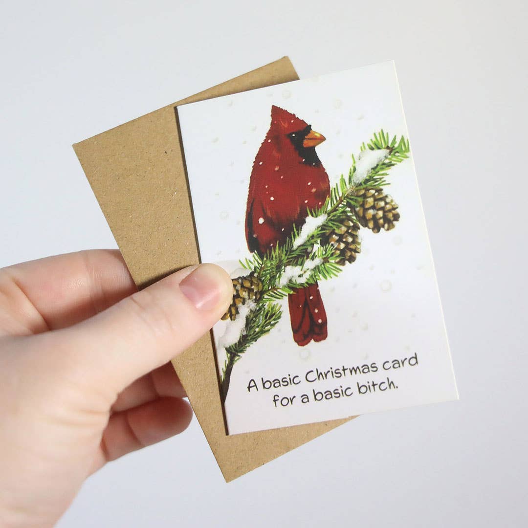 Mellow Monkey mini Christmas card featuring a cardinal on a pine branch with the text A basic Christmas card for a basic bitch