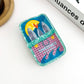 Mellow Monkey sardine can hair claw clip in blue and pink acrylic with a quirky fish and lemon graphic design.