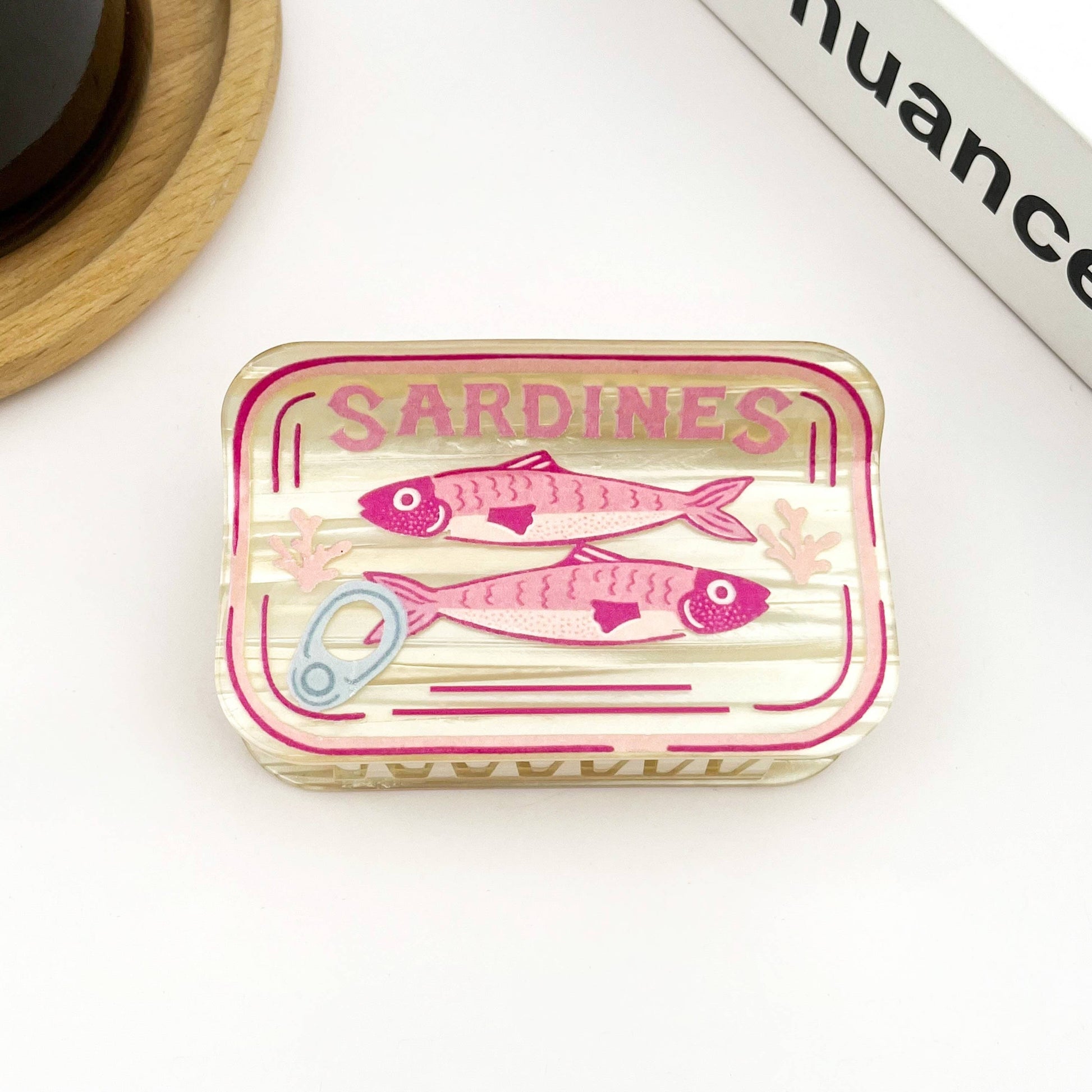 Mellow Monkey sardine can hair claw clip in translucent cream with pink fish graphic and pull tab detail