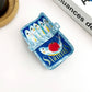 Mellow Monkey sardine can hair claw clip in blue with a whimsical fish and tomato illustration.