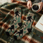 Mellow Monkey Sasquatch sleeper crew socks with a plush, fuzzy texture, featuring a black sasquatch and tree pattern.