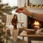 Mellow Monkey Sasquatch Old World Christmas blown glass ornament, brown, detailed fur texture, hanging on a tree.