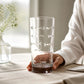 Mellow Monkey 15-oz highball glass with diamond-wheel engraved school of fish design on a table