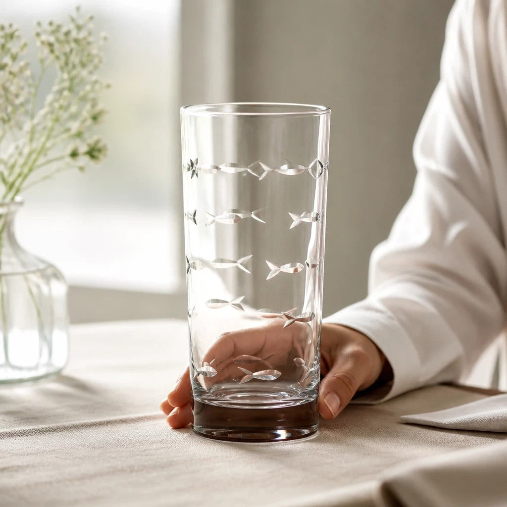 Mellow Monkey 15-oz highball glass with diamond-wheel engraved school of fish design on a table