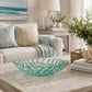Mellow Monkey sea foam glass coral bowl centerpiece on a wooden coffee table in a coastal living room.