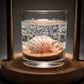 Mellow Monkey Sea Shell Beach Treasure double wick gel candle with seashells and sand in a glass jar.