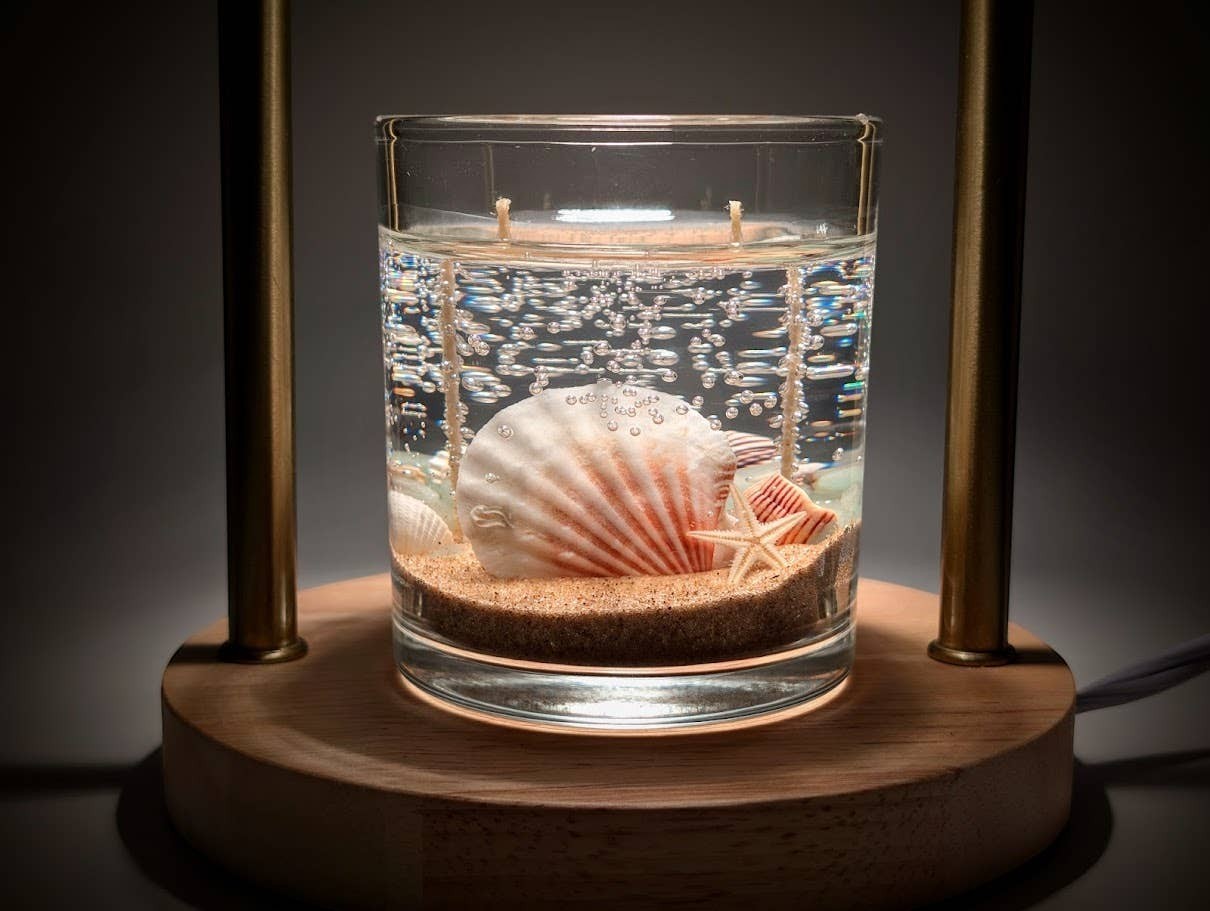 Mellow Monkey Sea Shell Beach Treasure double wick gel candle with seashells and sand in a glass jar.