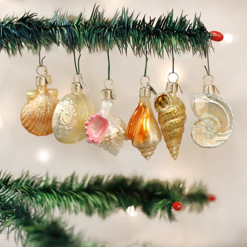 Mellow Monkey assorted glass sea shell ornaments in gold, white, and pink hues, with glitter accents.