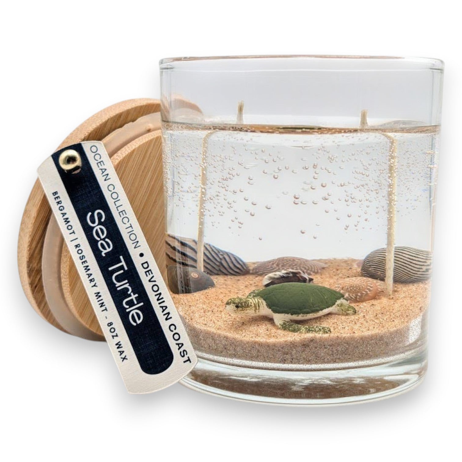 Mellow Monkey Sea Turtle gel candle with sand, seashells, and double wicks in a glass jar with a wooden lid.
