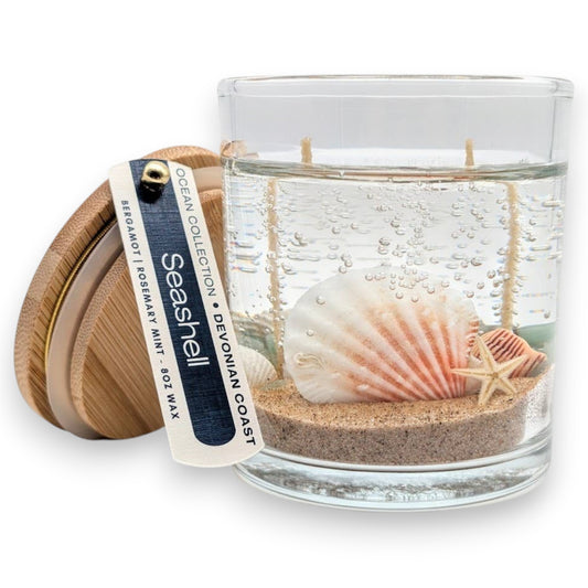Mellow Monkey Sea Shell Beach Treasure double wick gel candle with sand, seashells, and a bamboo lid.