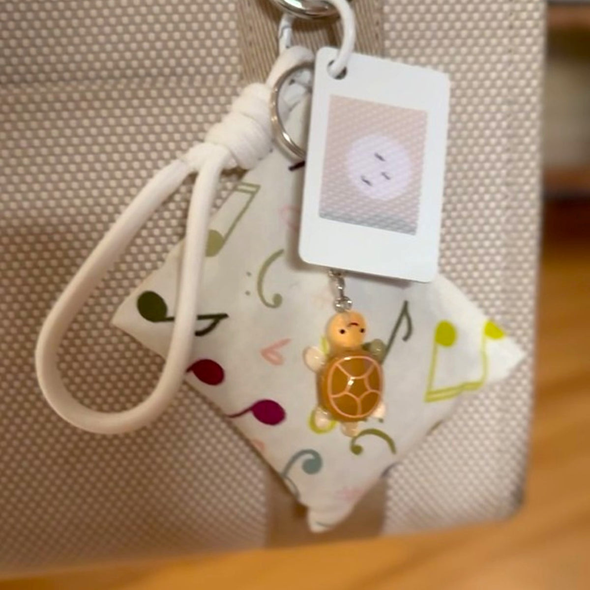 Mellow Monkey Carry Your Calm sensory fidget bag charm with turtle charm and card holder attached to a tote bag