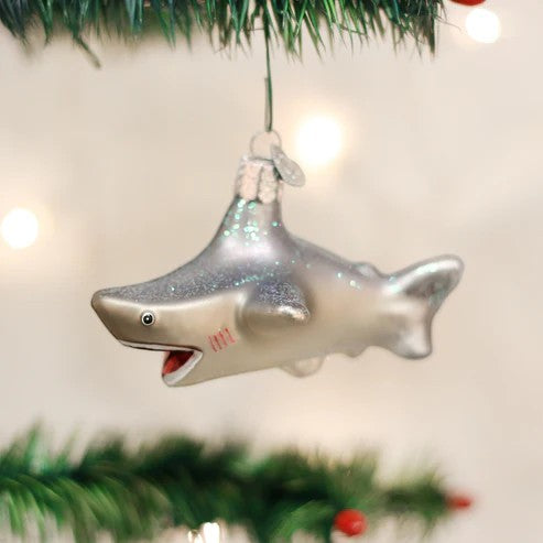 Mellow Monkey Old World Christmas blown glass shark ornament, silver with glitter accents, hanging on a tree.
