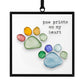Mellow Monkey Sharon Nowlan suncatcher featuring a colorful pebble art paw print design with the text Paw Prints On My Heart.