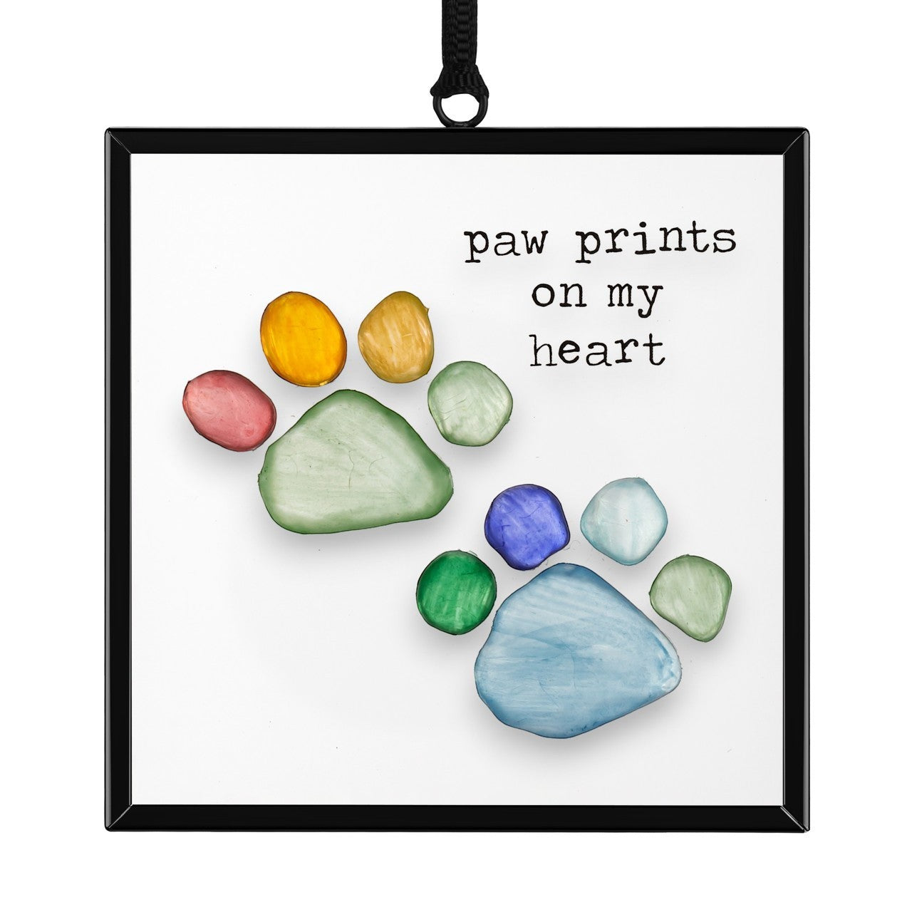 Mellow Monkey Sharon Nowlan suncatcher featuring a colorful pebble art paw print design with the text Paw Prints On My Heart.