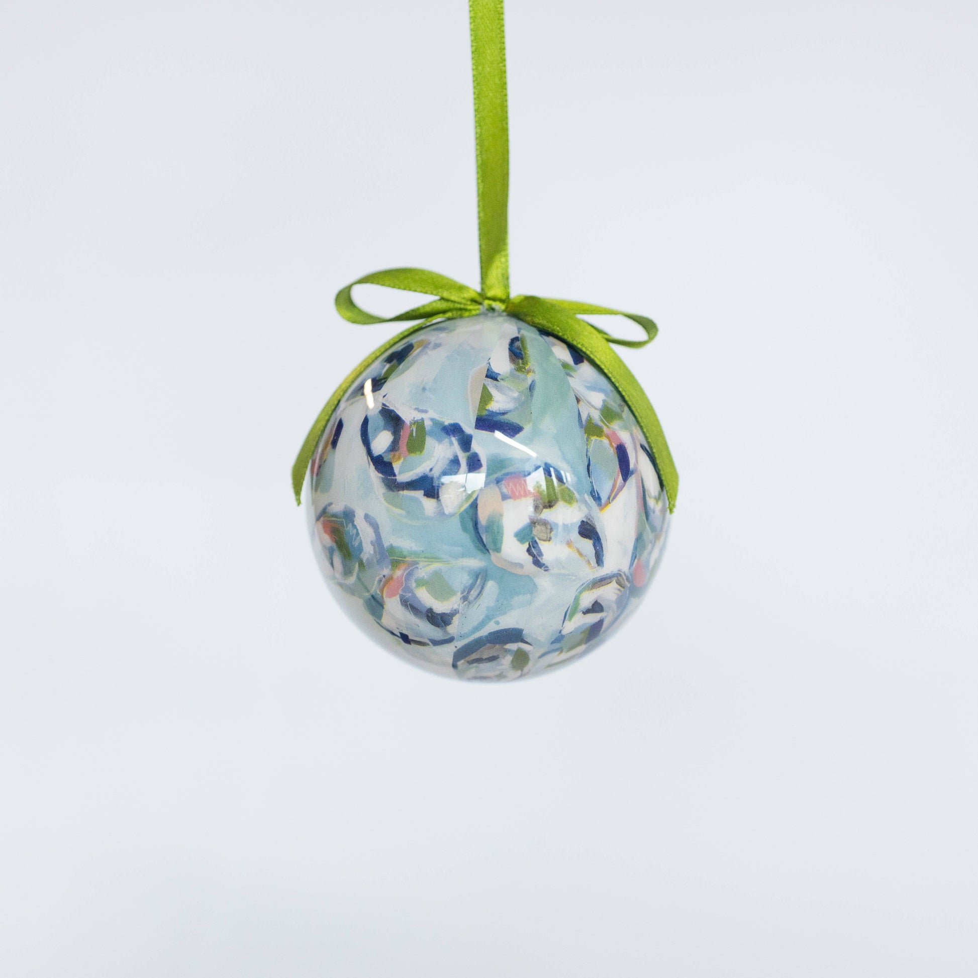 Mellow Monkey decoupage shell trio ornament featuring blue and white abstract art with a green ribbon hanger