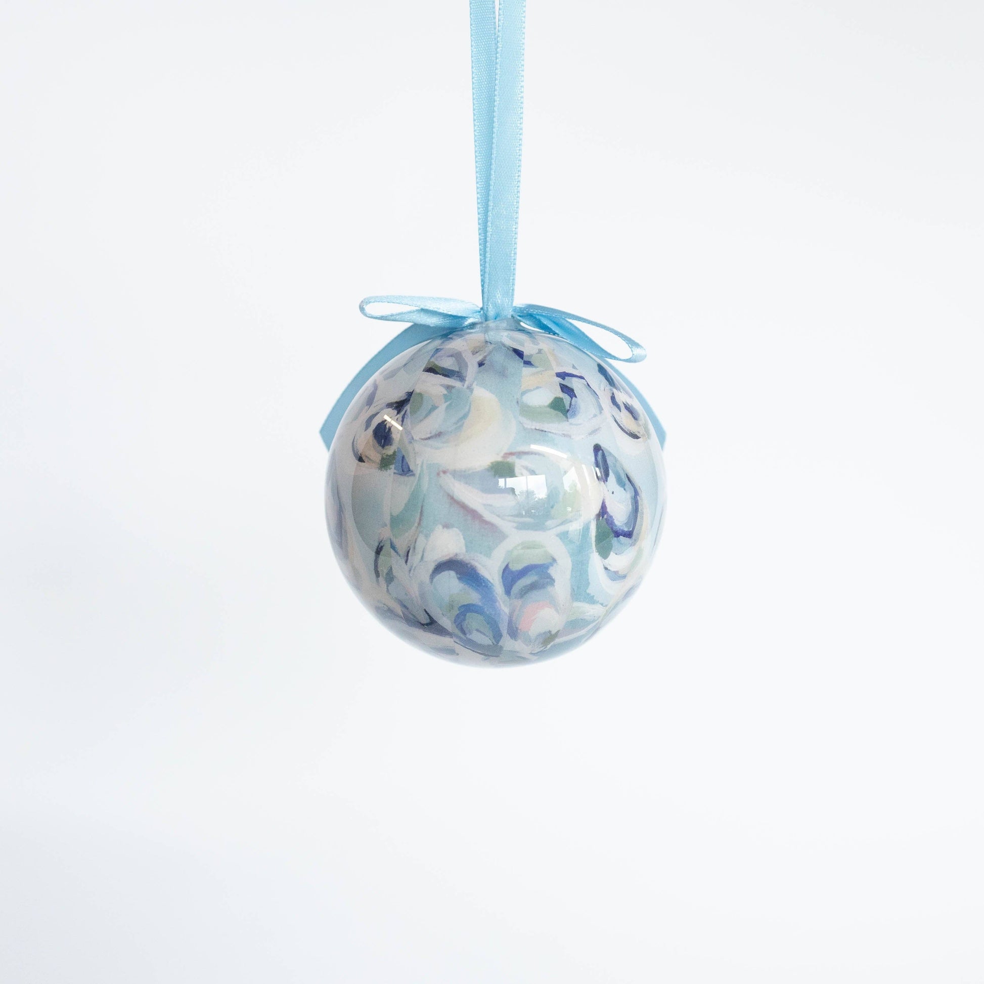 Mellow Monkey Kim Hovell shell trio decoupage ornament with blue ribbon hanging against a white background