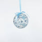 Mellow Monkey decoupage glass ornament featuring a blue and white shell pattern with a matching light blue ribbon.