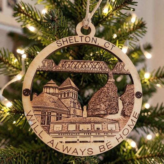 Mellow Monkey Shelton CT Will Always Be Home wooden ornament with laser-cut landmarks hanging on a Christmas tree.