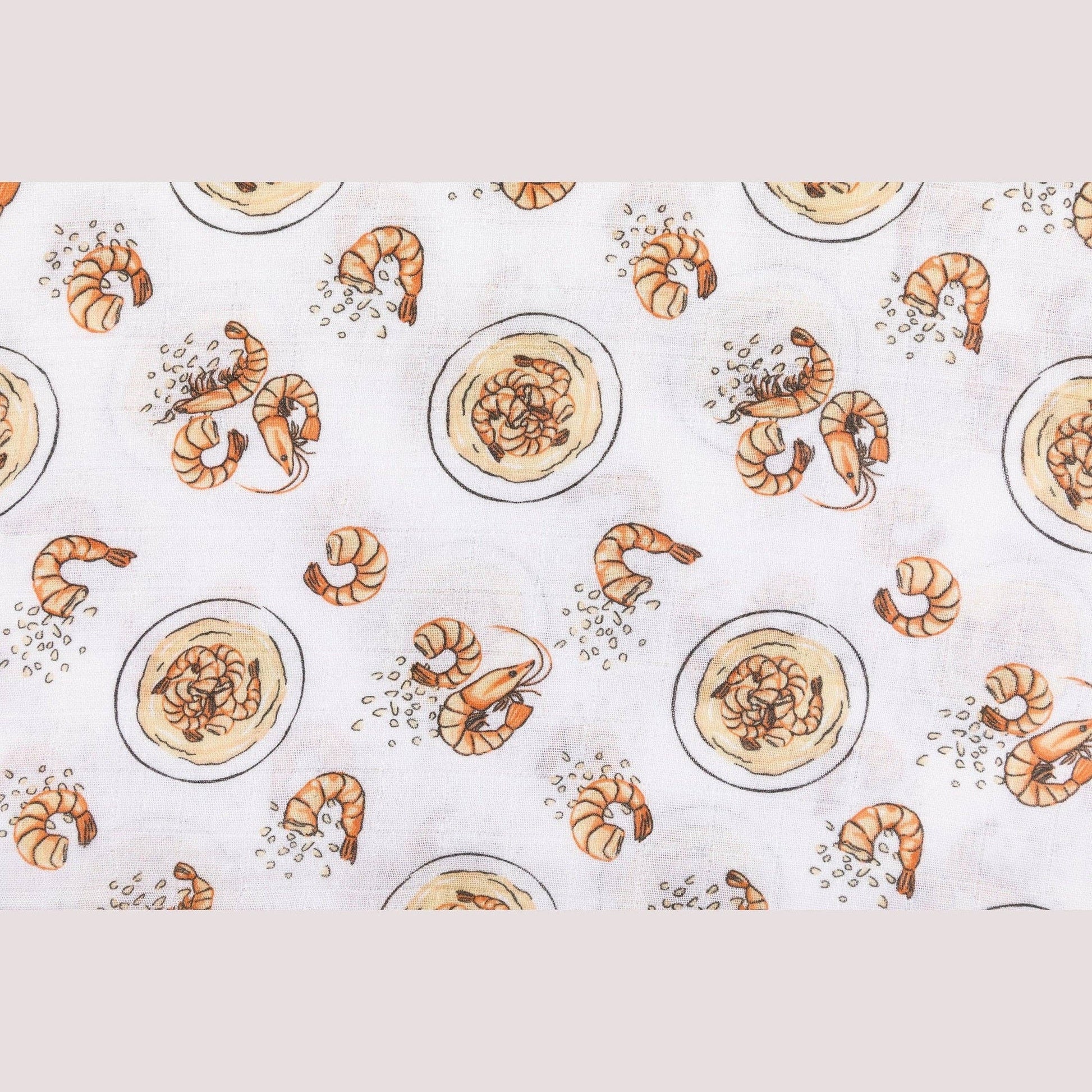 Mellow Monkey muslin swaddle blanket featuring a playful shrimp and grits pattern on a soft white fabric background.