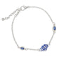 Mellow Monkey silver anklet featuring a blue and white enamel fish charm and two teardrop blue crystal accents.