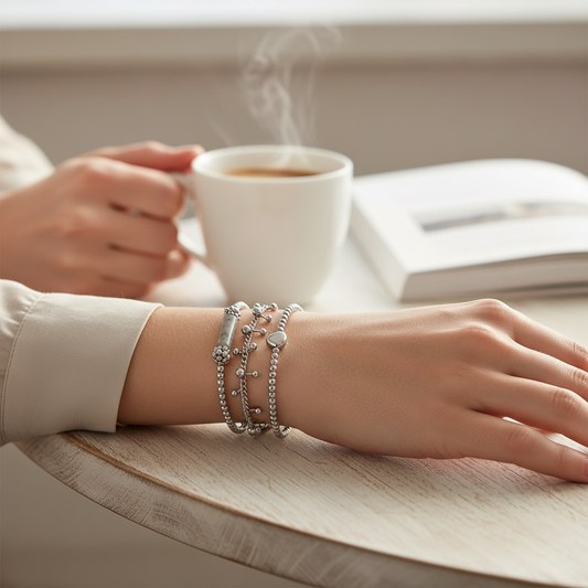 Mellow Monkey Narelle waterproof silver beaded bracelet set with heart and amethyst accents on a woman's wrist