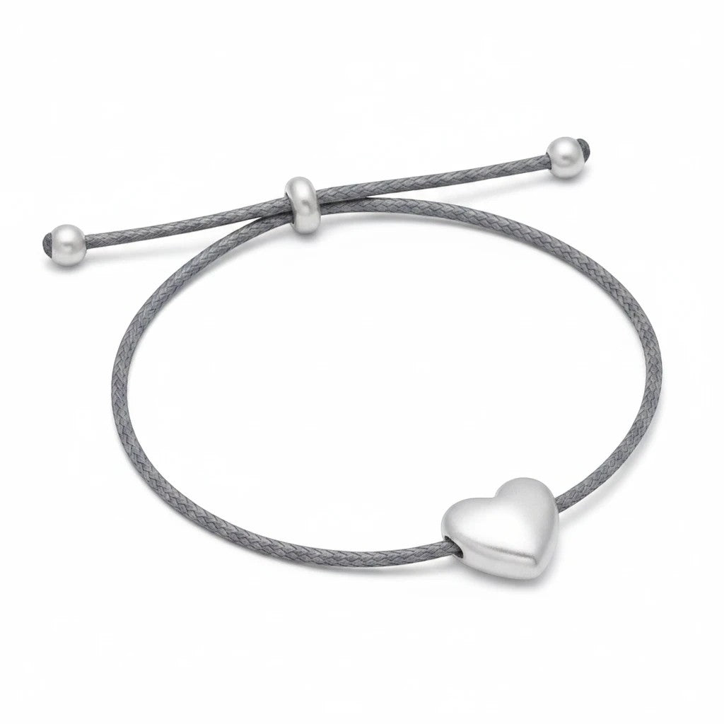 Mellow Monkey slate blue cord bracelet featuring a polished silver heart charm and adjustable sliding beads.