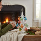Mellow Monkey 13-inch silver LED tabletop tree decorated with colorful glass ornaments near a cozy fireplace.