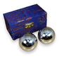 Mellow Monkey Silver Therapy Balls in a blue patterned box. Shiny spheres for stress relief and meditation.