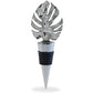 Mellow Monkey silver metal wine stopper featuring a detailed tropical monstera leaf design with a black rubber seal.