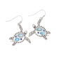 Mellow Monkey silver turtle earrings featuring blue stone inlays, perfect for coastal beach style jewelry.