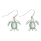 Mellow Monkey silver turtle earrings featuring a smooth mint green inlay on a white background.