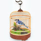 Mellow Monkey motion-activated blue and white singing bird toy inside a decorative hanging cage