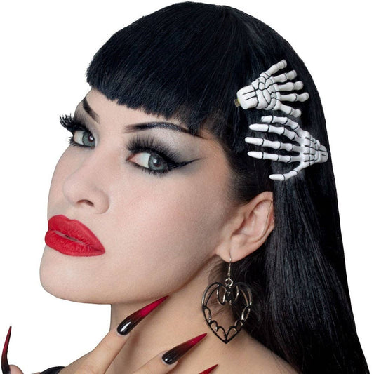 Mellow Monkey white skeleton bone hand hairslides worn by a woman with black hair and gothic makeup.