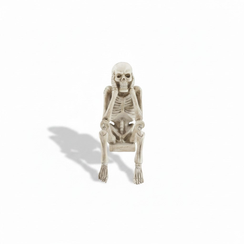 Mellow Monkey resin skeleton shelf sitter in a weathered bone finish, posing with hands covering ears.