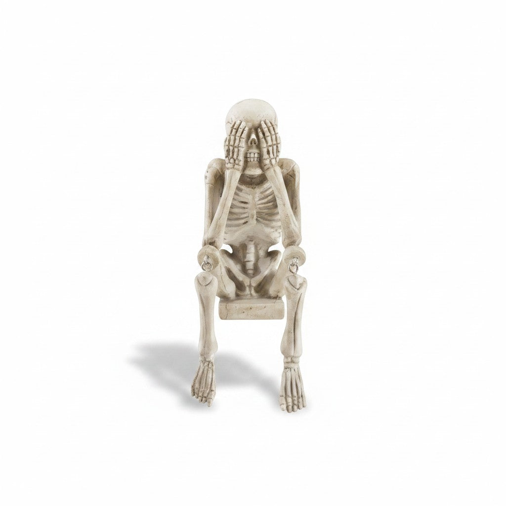 Mellow Monkey resin skeleton shelf sitter in a bone finish, posing in the see no evil position on a white background.
