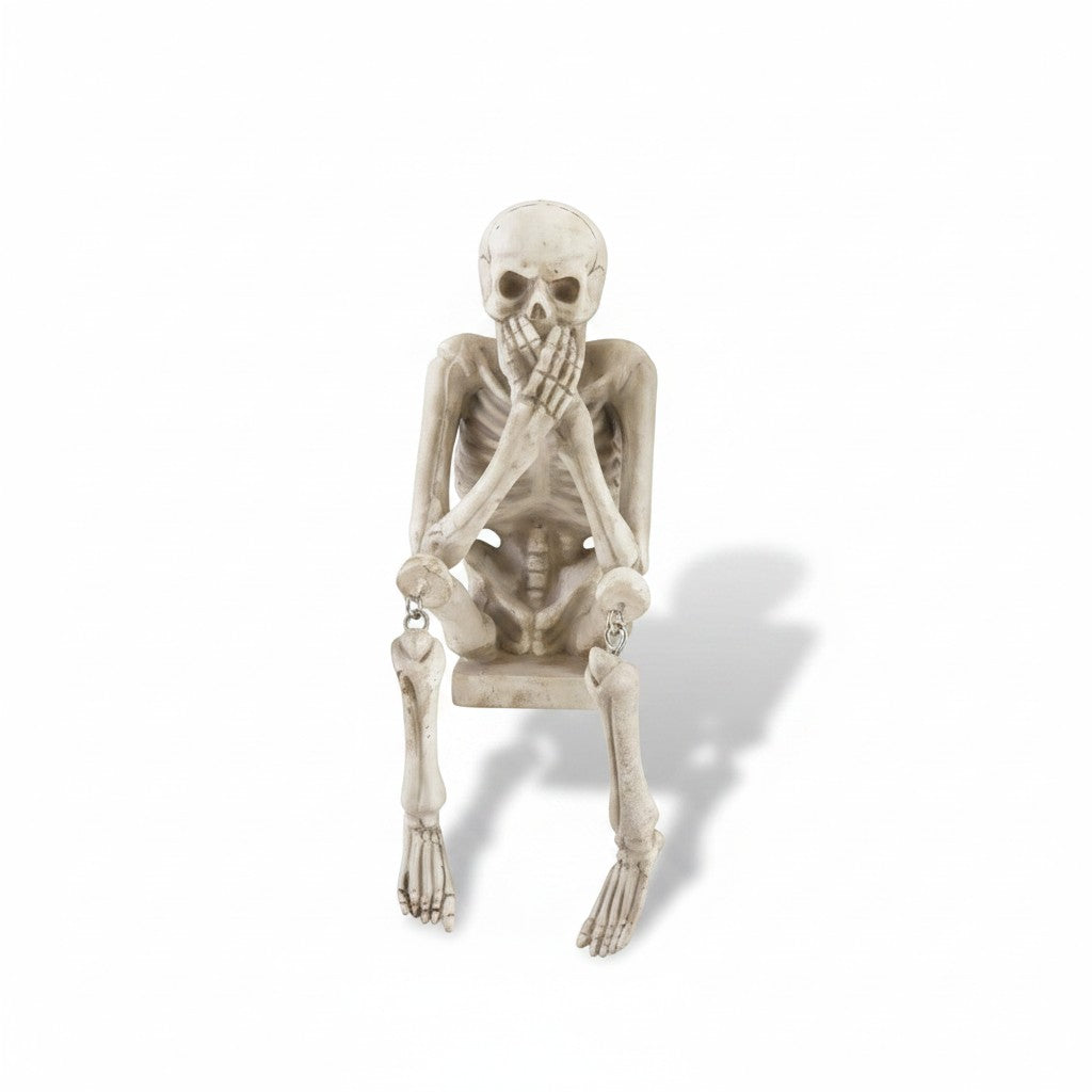 Mellow Monkey resin skeleton shelf sitter in a speak no evil pose with a weathered bone finish
