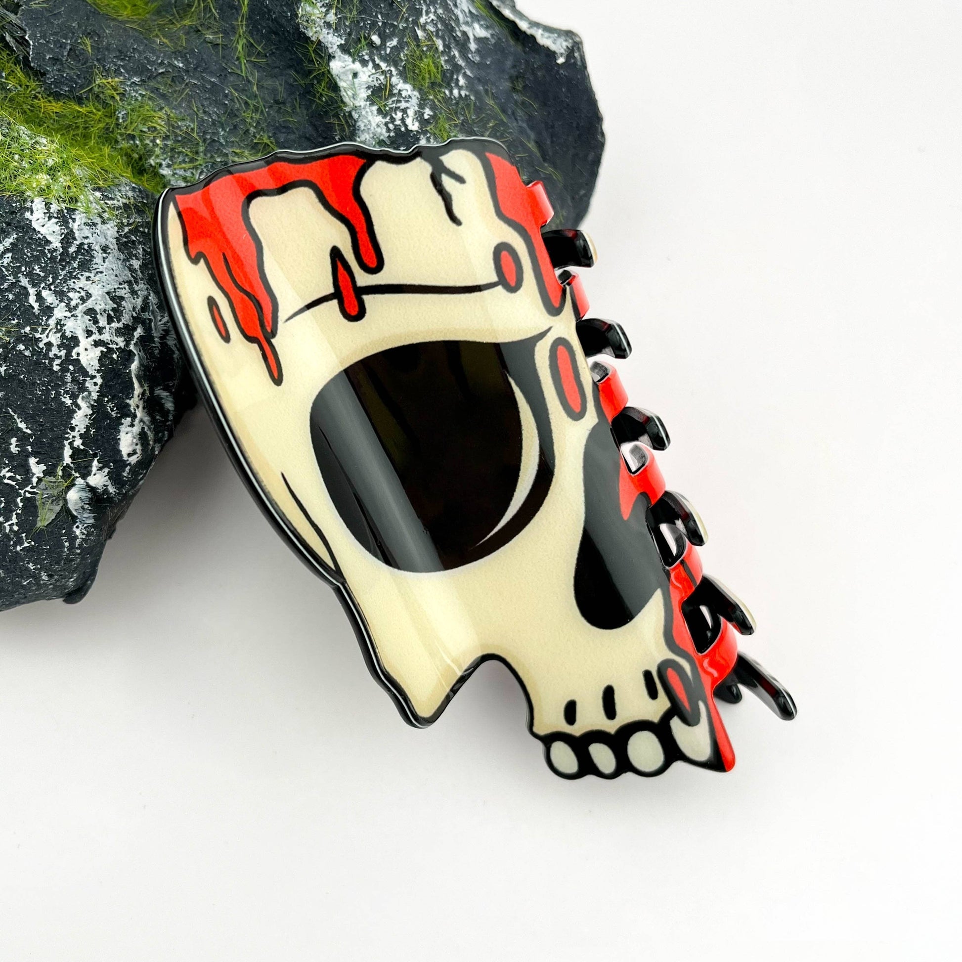 Mellow Monkey skull-shaped Halloween hair claw clip with cream, black, and red blood-drip design.