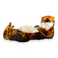 Mellow Monkey brown tortoiseshell sleeping otter hair claw clip resting on a mossy rock