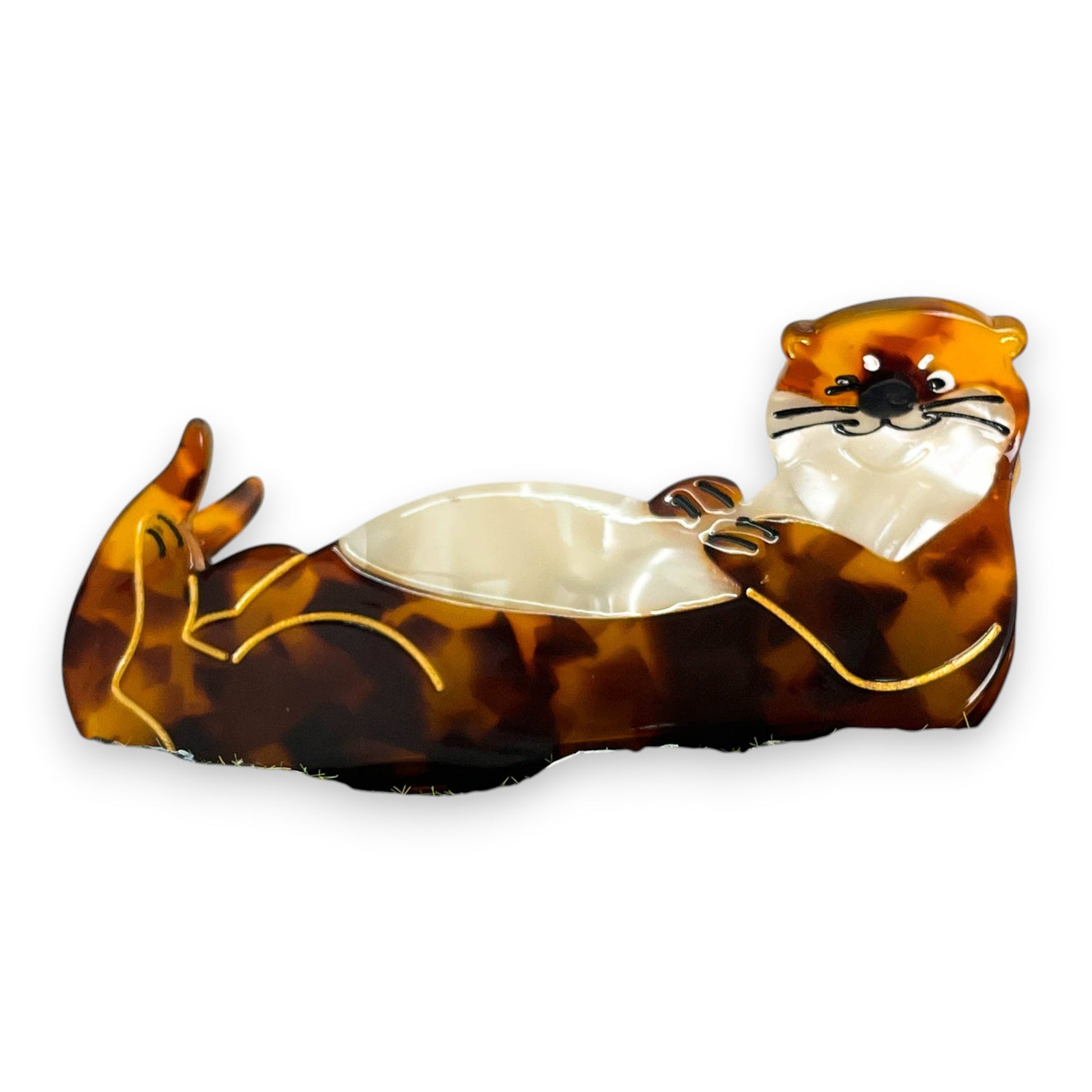 Mellow Monkey brown tortoiseshell sleeping otter hair claw clip resting on a mossy rock