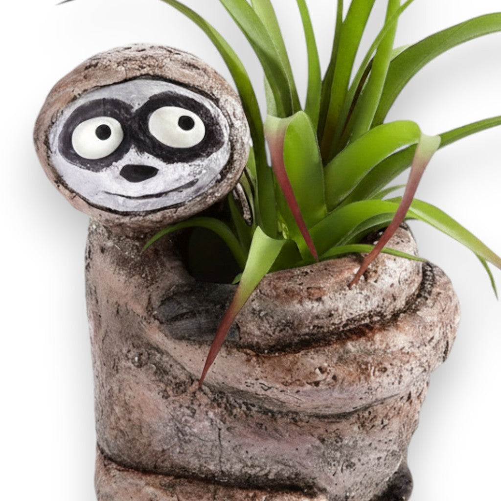 Mellow Monkey Sitting Sloth Blobhouse Planter, handcrafted poly-resin, brown, with a cute face and holding a plant.
